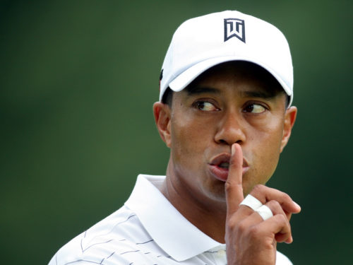 Tiger Woods of the United States gestures to a fan to be quiet from the fifth green during first round play at the WGC Bridgestone Invitational golf tournament in Akron, Ohio August 6, 2009. REUTERS/Aaron Josefczyk (UNITED STATES SPORT GOLF) - RTR26GXI