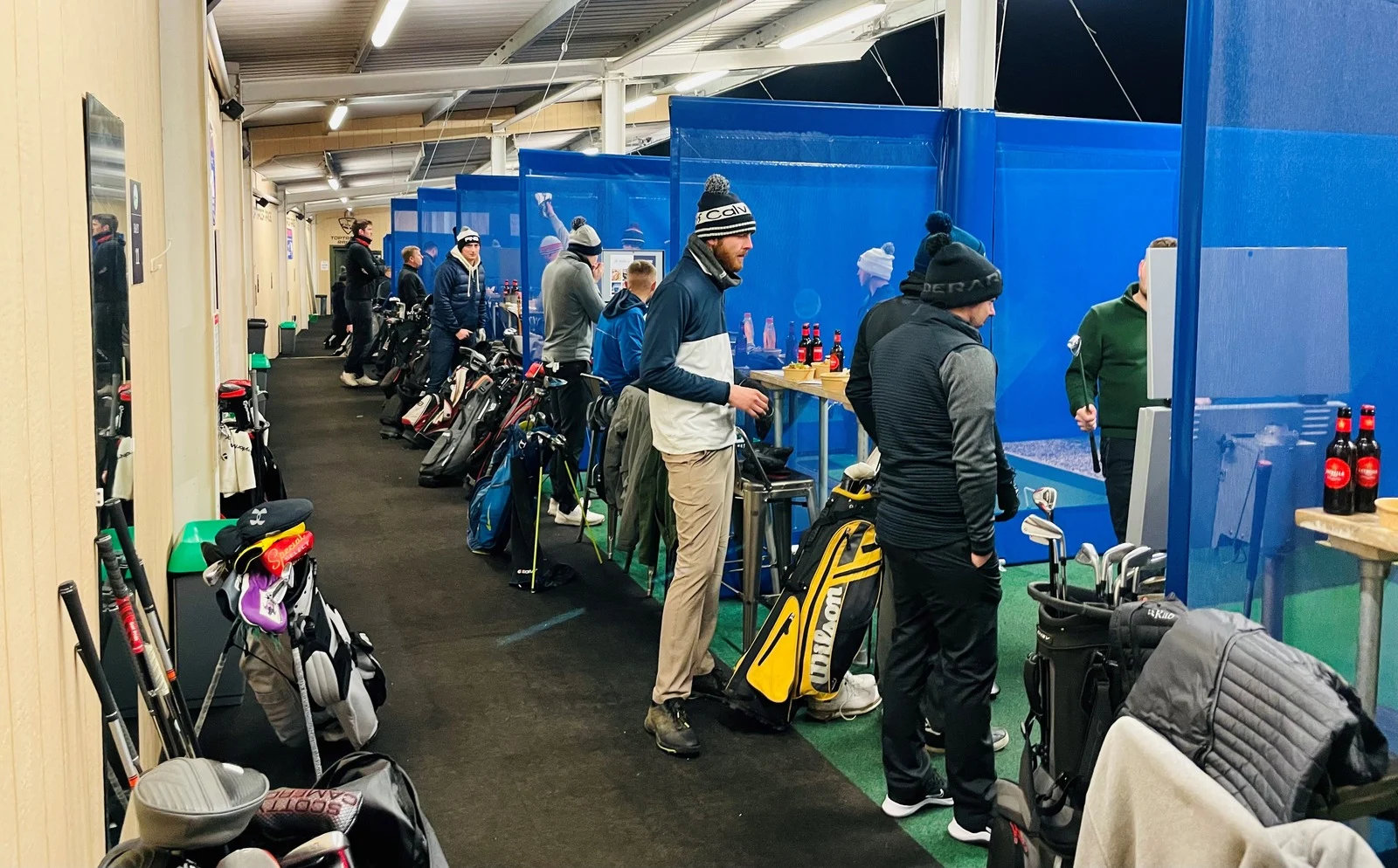 Players in the covered, heated Toptracer bays at Winchester Golf Academy