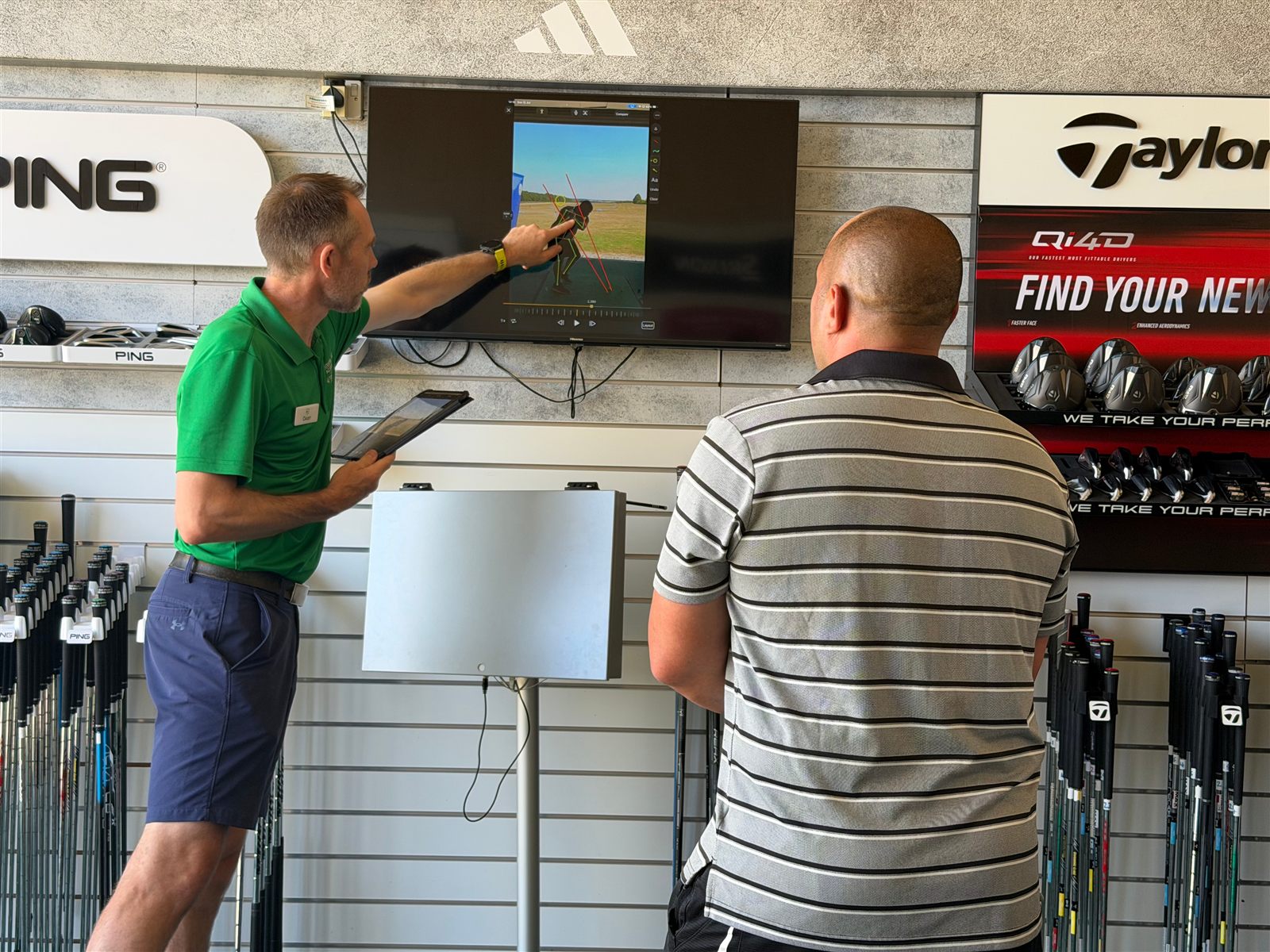 Dean Harrison coaching a golfer through their swing at Winchester Golf Academy