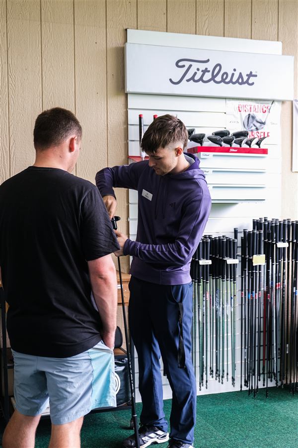 Choosing a shaft from the demo wall during a custom fitting at Winchester Golf Academy