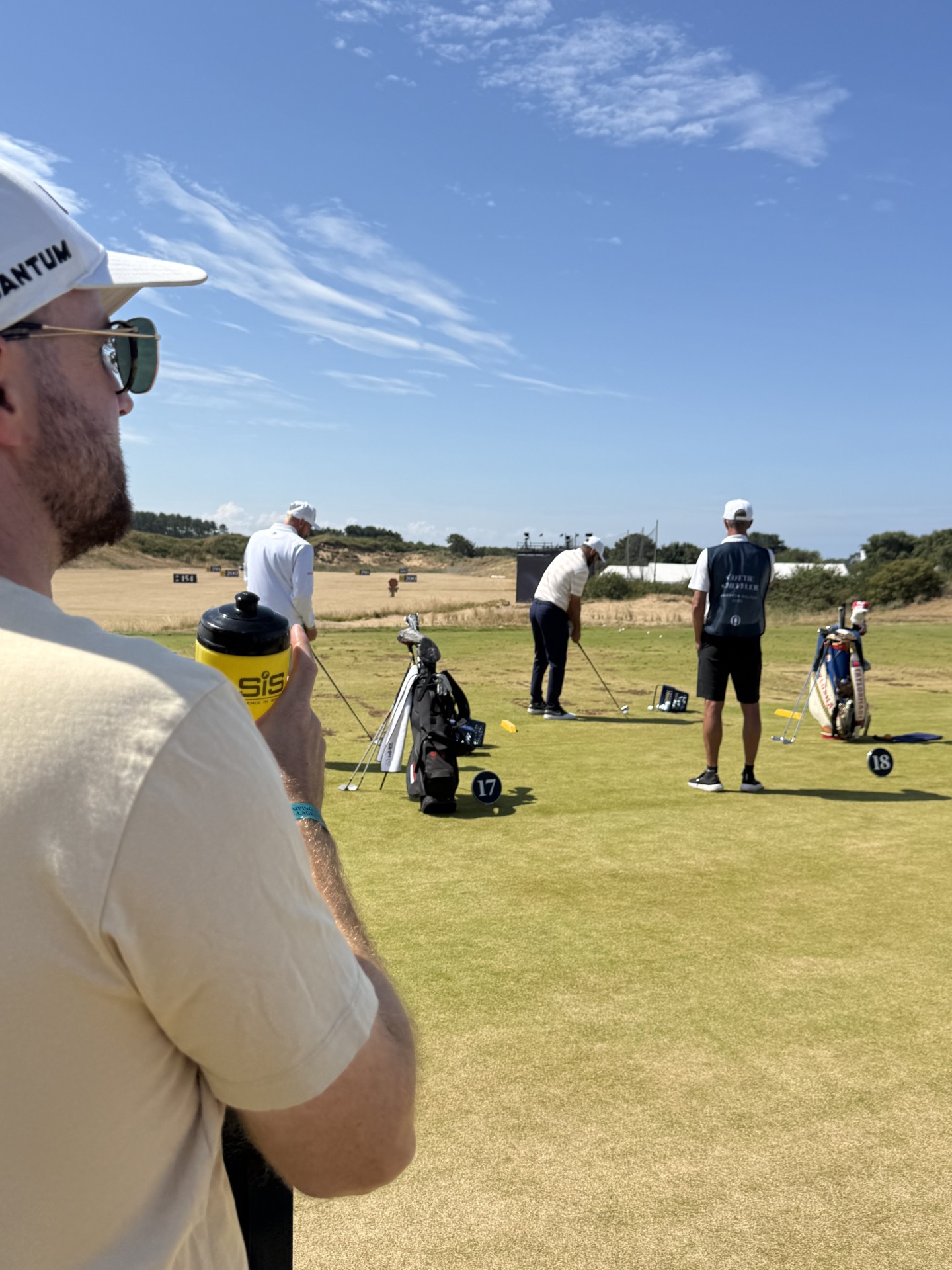 Scottie Scheffler warming up on the practice range on Sunday at The Open, watched by Gary Booth
