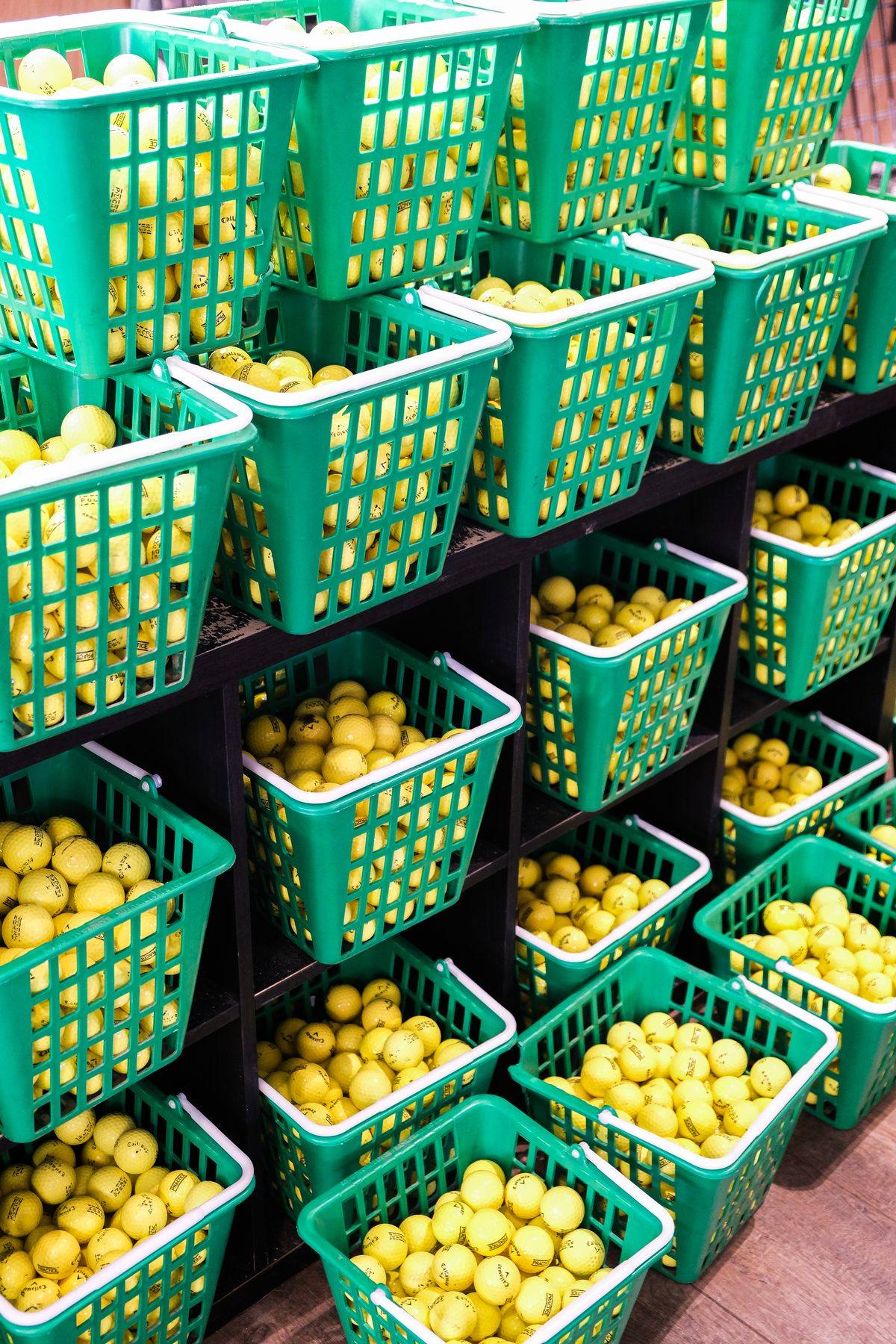 Baskets of range balls stacked and ready at Winchester Golf Academy
