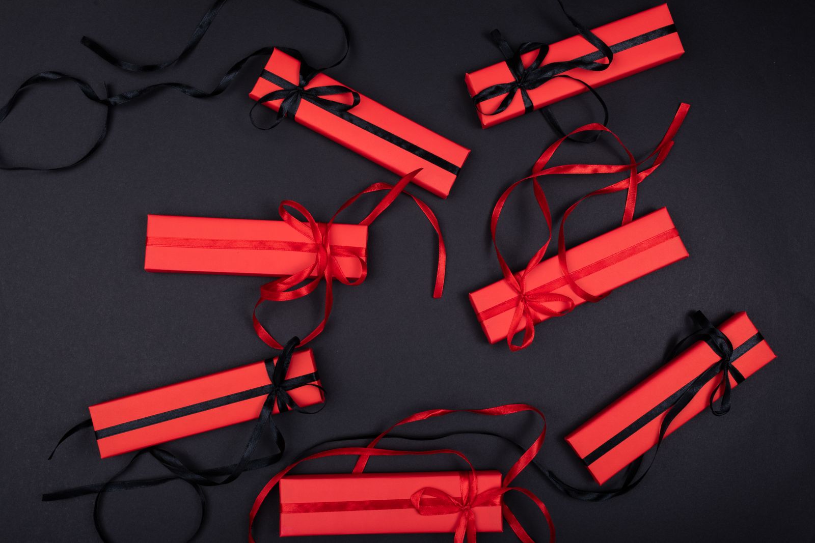 Wrapped Christmas gift boxes in red with black and red ribbon